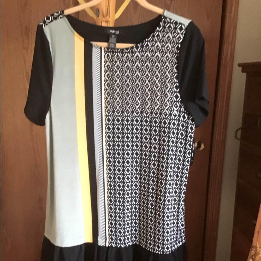 Cute top with leggings or mini dress if you dare!  New with tag never worn.